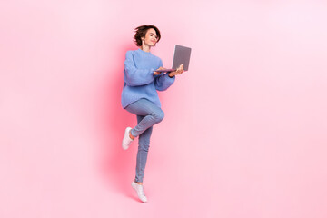 Full size photo of pretty good looking jumping business lady working in netbook isolated on pink color background