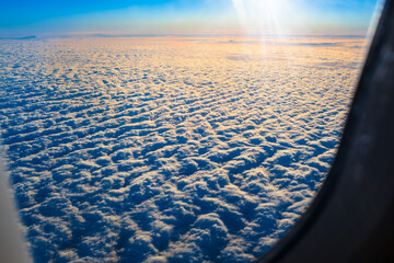 Flight to Sunrise / View from plane window to rising sun above blanket of clouds (copy space) - 499767433