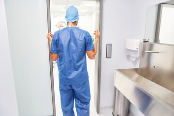 Surgeon stands in front of the operating room after disinfection