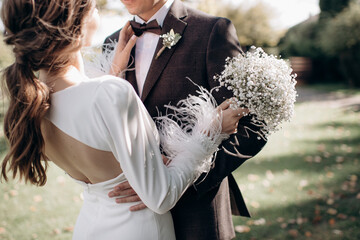 groom hugging bride by the waist