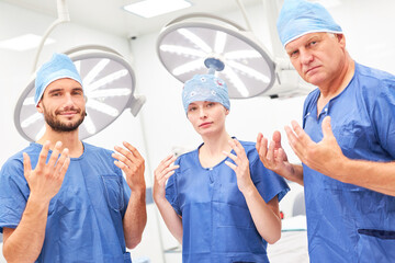 Surgery team with sterile hands after disinfection