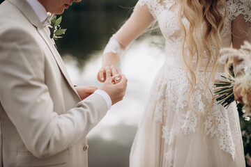 newlyweds exchange wedding rings at a ceremony