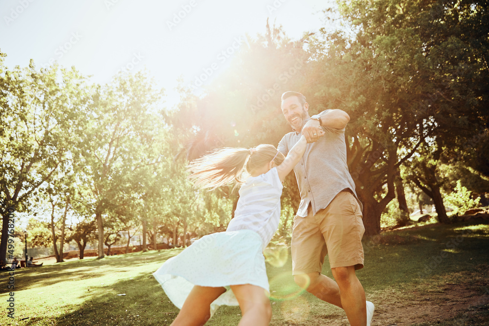 Canvas Prints Kids find joy in the simplest of moments. Shot of an adorable little girl being swung around by her father in the park.