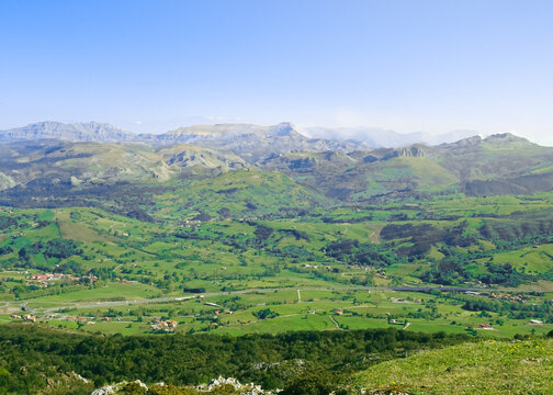 Views of the green Pas region valleys (Valles Pasiegos) and its peaks: Fraile peak (Pico Fraile) and Castro Valnera peak (Pico Castro Valnera). At Pe&ntilde;a Cabarga Llen peak in Santander, Cantabria.