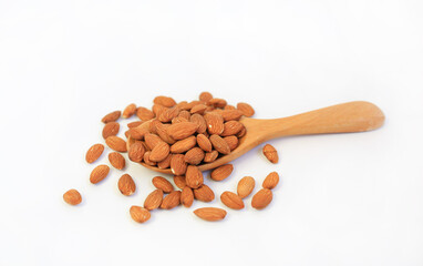 Almonds nuts in wooden spoon isolated on a white background