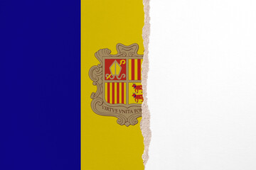 Half- ripped paper background in colors of national flag. Andorra