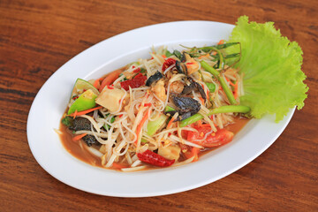 Papaya Salad (Som Tam Pa) the traditional Thai foods on wood table background. Most wanted popular food in Thailand.