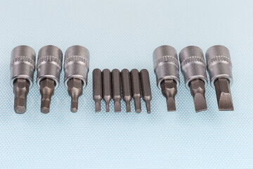 Sets of different interchangeable flat and hexagonal bits for screwdriver