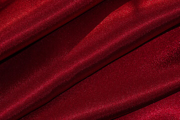 Close up of deep dark red draped textile material.
