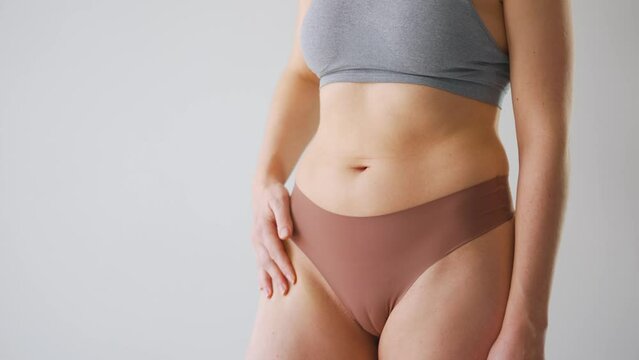Woman checks the condition and elasticity of the skin of the body.