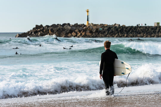 Surfer pondering his entrance to Les Cavaliers Beach. Anglet