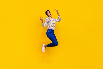 Full size portrait of carefree excited person hands fingers demonstrate v-sign isolated on yellow color background