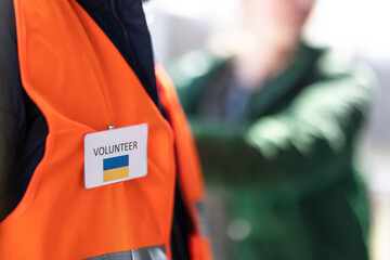 Volunteer registring Ukrainian refugees at train station, close-up