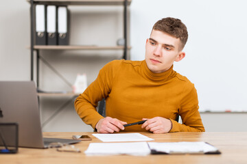 handsome young man working with documents in the office