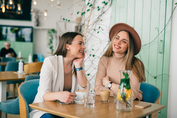women enjoying coffee break in cafe