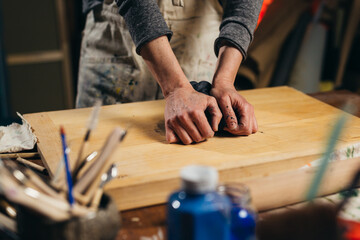 close up woman preparing clay for making pottery