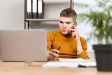 young successful man working with documents in the office