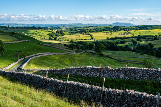 Road through countryside to Malham, North Yorkshire, England, UK