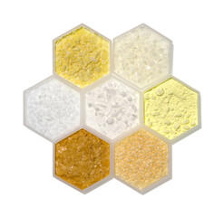 Chemical ingredient in hexagonal molecular shaped container. Sodium Sulfide Flakes, Microcrystalline Wax, Polyethylene, Cetyl Esters Wax, Sulfur Powder, Carnauba Wax and Candelilla Wax.
