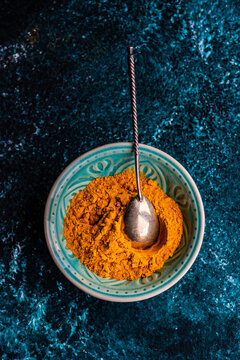 Overhead view of a bowl of turmeric powder