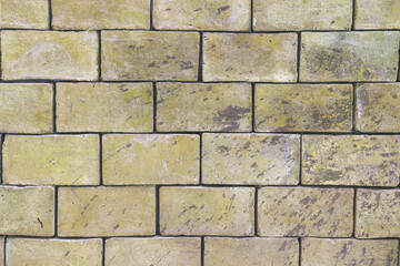 Background brick wall texture of light beige greenish shades of large blocks