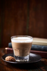 Coffee with milk on rustic wooden background. Soft focus. Close up. Copy space.