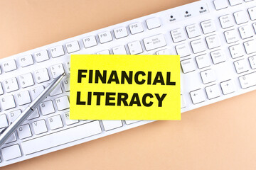 Text FINANCIAL LITERACY text on a sticky on keyboard, business concept