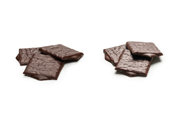 Dark chocolate candies isolated on white background.