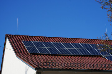 Solar Module auf einem Dach im Sonnenschein. Bei dem blauen Himmel kann im Frühling viel Strom...