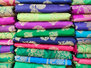 Rolls of fabric and textiles in shop. Multi colors indian patterns on the market Fabrics in rolls. Fabric store in Pune, Maharashtra, India.