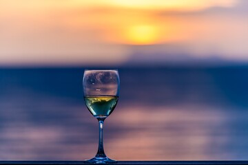 Glass of white wine against a sunset