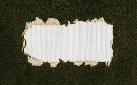 Torn hole in cardboard, light background of canvas, copy space