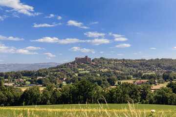 Perspective view to Chateau de Castelnau-Bretenoux standing at very end rocky plateau overlooking...