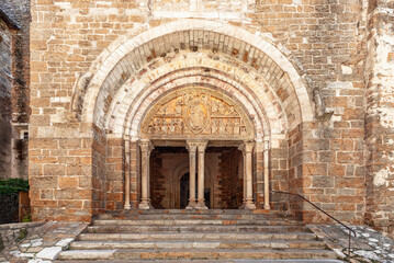 Fototapeta na wymiar 12th century tympanum is marvelous piece of sculpture, mounted on portal above staircases of columns entrance to narthex of Church Eglise Saint-Pierre de Carennac. Lot, Occitanie, France