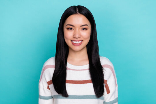 Photo of young cheerful adorable filipino lady with long black hair wear comfy sweater isolated on teal color background