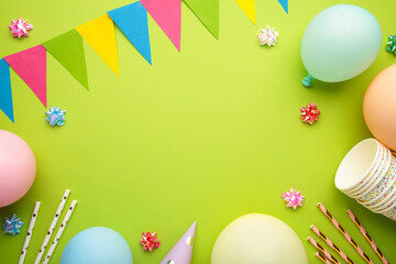 Colorful carnival or party frame of balloons, streamers and confetti on green background. Space for...