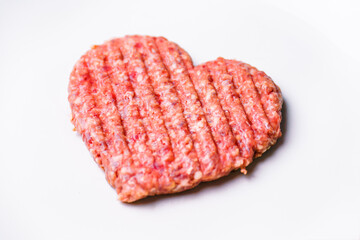 Meat cutlet in the shape of a heart. Dinner for lovers on February 14th. Meat love. Valentine's Day. Mince heart