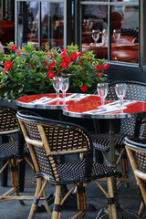 Charming terrace of the typical Parisian restaurant with red flowers