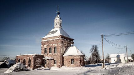 red brick village church in winter