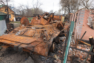 Fototapeta premium Russian infantry fighting vehicle (BMP) in the courtyard of civilians, in the village of Brovarsky district, Kiev region. Footage of Ukrainian and Russian soldiers destroyed after the battle