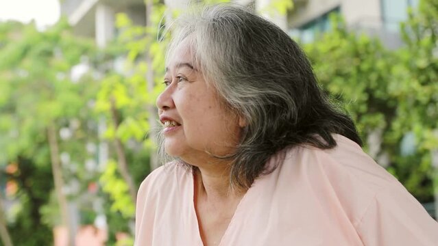 Portrait of an elderly woman in a hospital uniform using a cane, walking relaxed with a healthy smile and a better mind.
