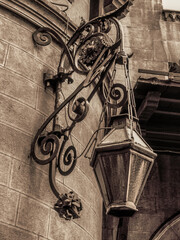 Large embroidered street lamp hanging on the wall of a historic church