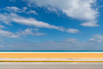 coastline with fence and yacht in ocean water