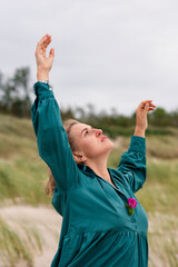 Woman dancing in a dress in nature