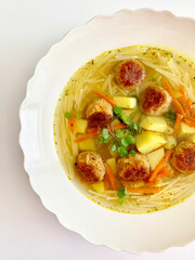 Vegetarian vegetable soup with lentil meatballs - 499790844