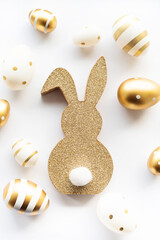 Cute easter bunny and golden eggs isolated on white background. Happy Easter minimal concept, greeting card. soft selective focus.