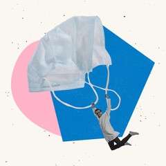 Contemporary art collage. Man flying on protective face mask like on parachute. Precautionary...
