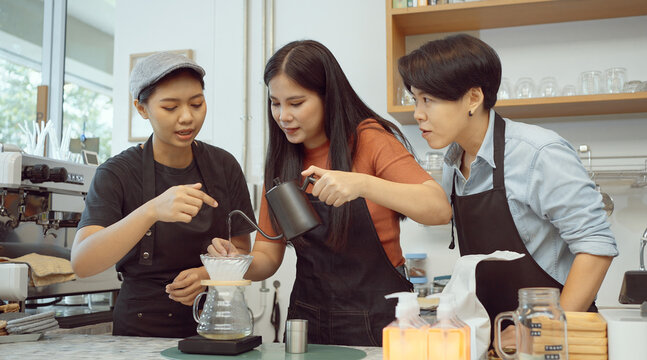 Three of Barista making coffee drip in the coffee cafe.