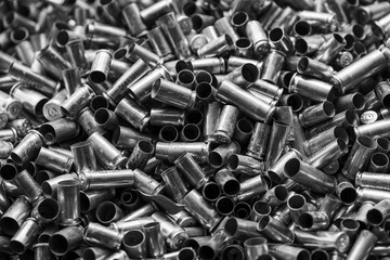 Bunch of empty pistol shells as a background. Pile of used pistol cartridges.