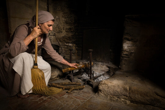 Rembrandt woman at medieval fireplace